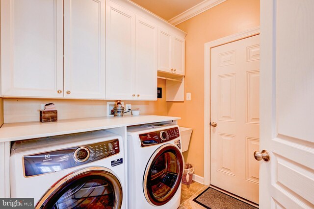 laundry room featuring cabinet space, light tile patterned floors, ornamental molding, and independent washer and dryer