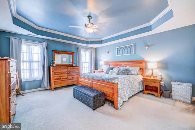 bedroom featuring visible vents, a tray ceiling, carpet flooring, and ornamental molding