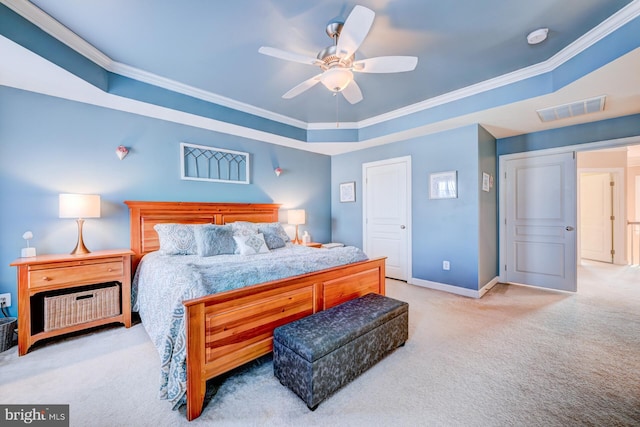 bedroom with baseboards, visible vents, a raised ceiling, crown molding, and carpet floors