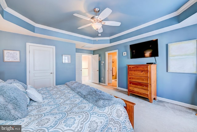 bedroom featuring ceiling fan, carpet floors, baseboards, a tray ceiling, and crown molding