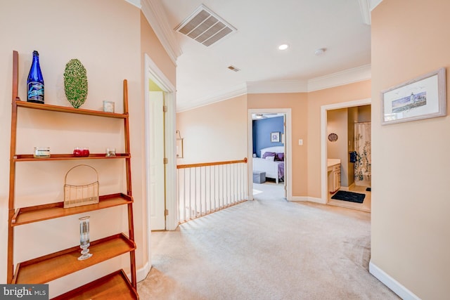 corridor featuring baseboards, visible vents, crown molding, carpet floors, and recessed lighting