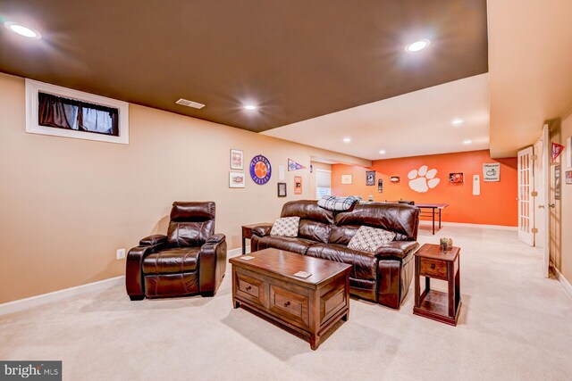 living room featuring recessed lighting, visible vents, and light carpet