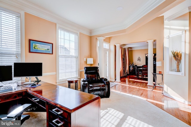 office with ornate columns, crown molding, and wood finished floors