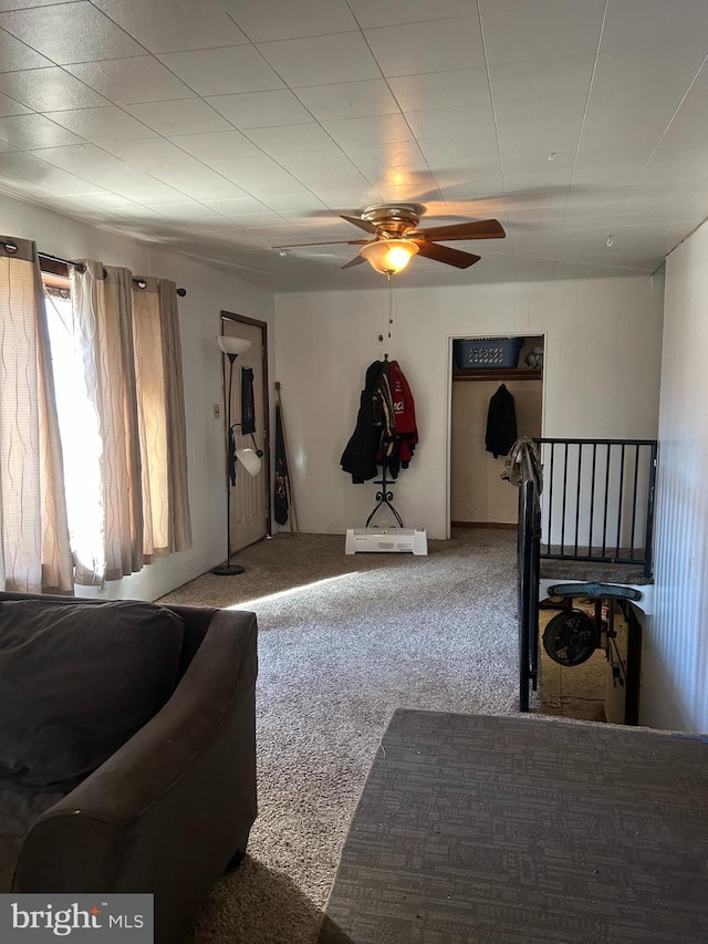 carpeted living room with a ceiling fan