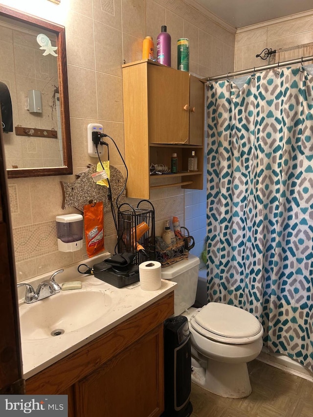 full bath with crown molding, tile walls, backsplash, toilet, and vanity