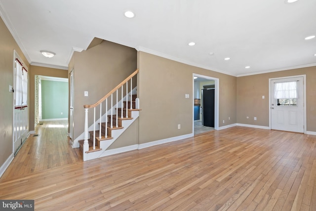 unfurnished living room with recessed lighting, baseboards, stairs, and light wood finished floors