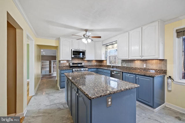 kitchen featuring stainless steel appliances, marble finish floor, and white cabinets