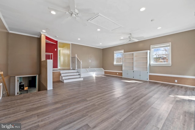 unfurnished living room featuring a ceiling fan, wood finished floors, attic access, recessed lighting, and crown molding