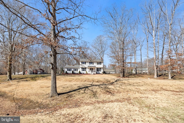 view of front of property featuring a porch and a chimney