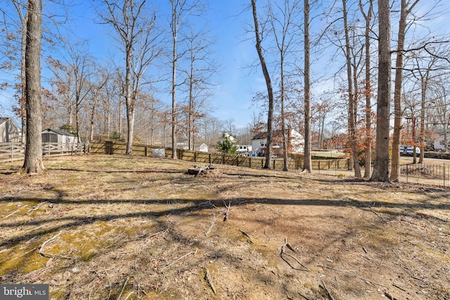 view of yard featuring an outdoor structure and fence