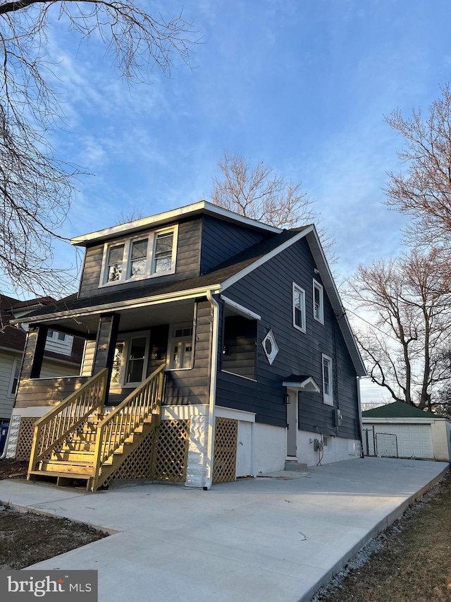 view of front of home with a porch and an outdoor structure