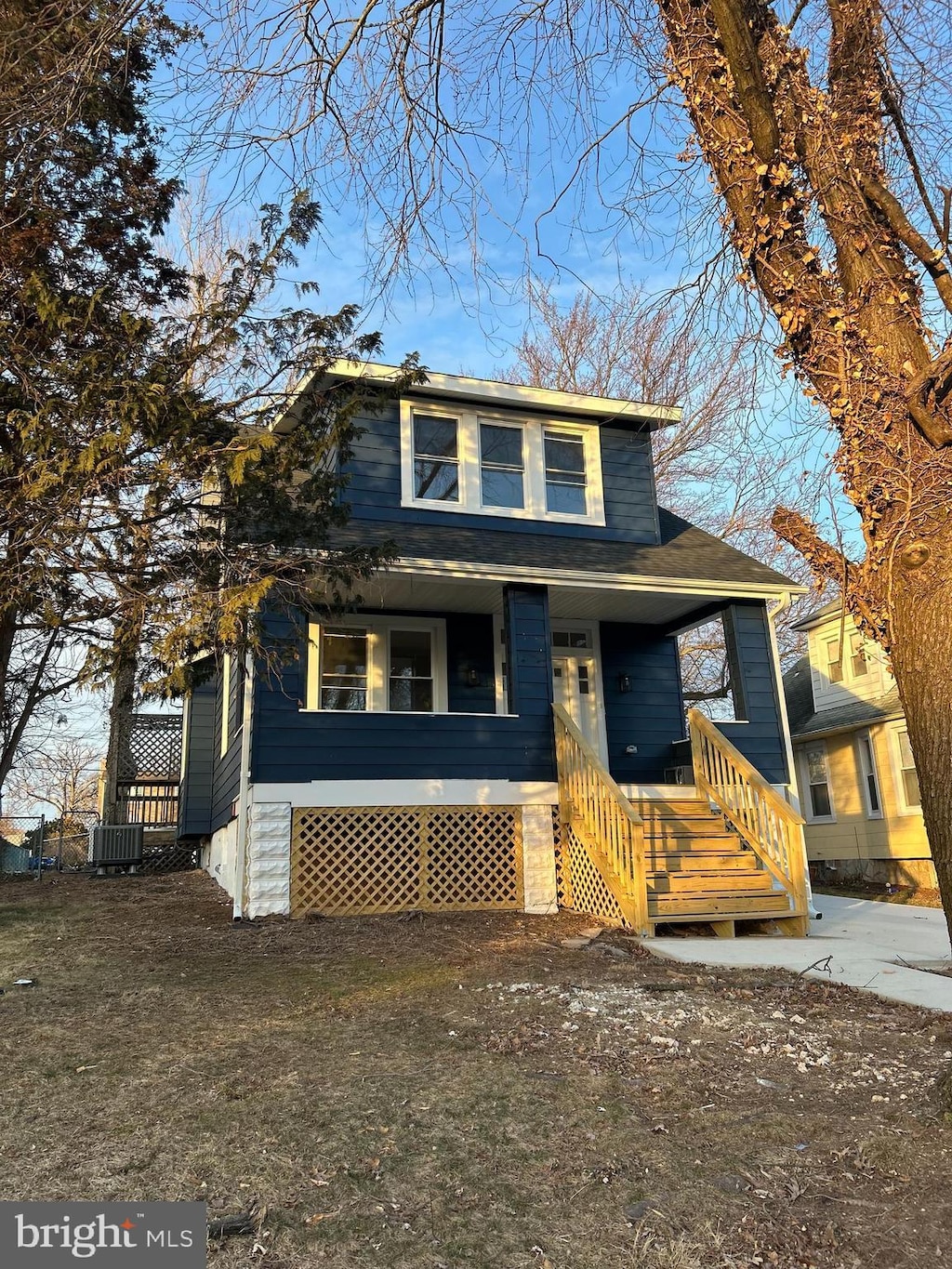 view of front of property featuring cooling unit and covered porch