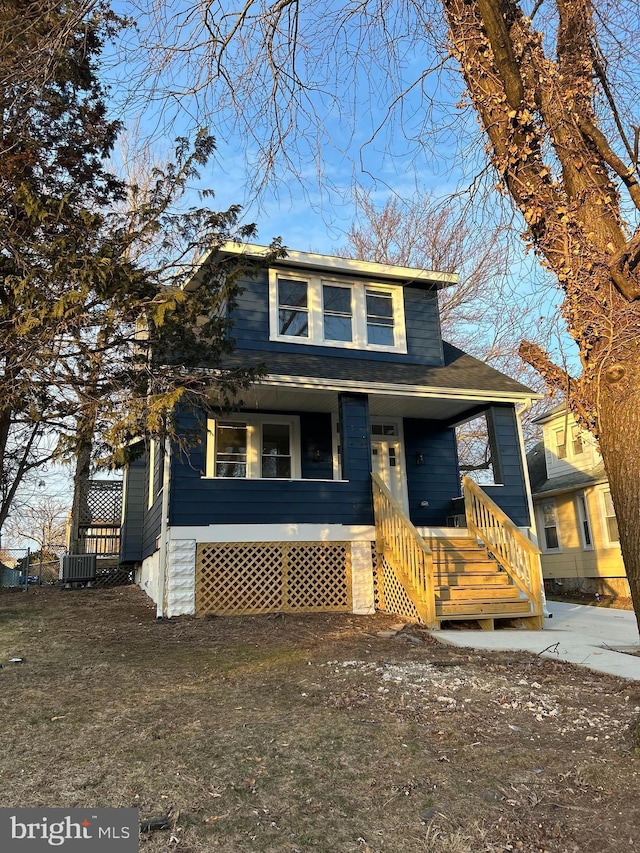 view of front of property featuring cooling unit and covered porch