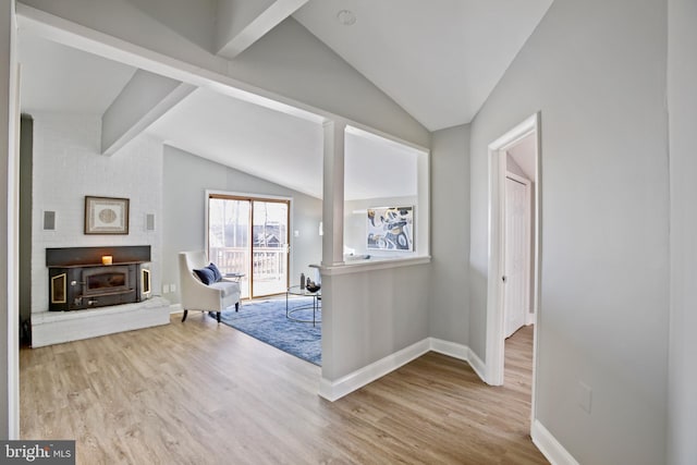 interior space with lofted ceiling with beams, baseboards, and wood finished floors