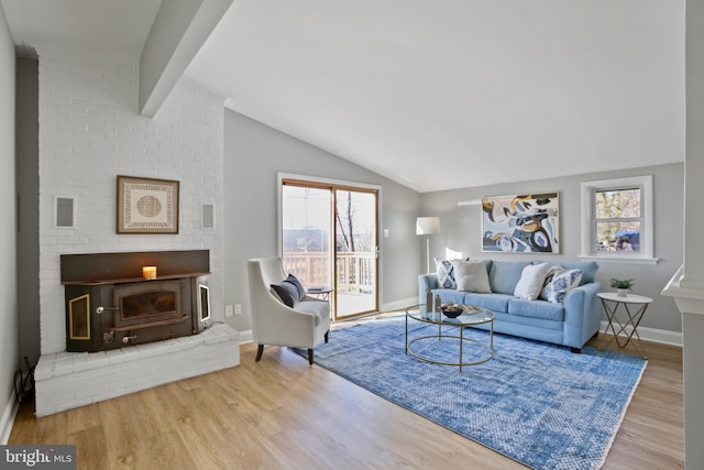 living room with vaulted ceiling with beams, visible vents, baseboards, and wood finished floors