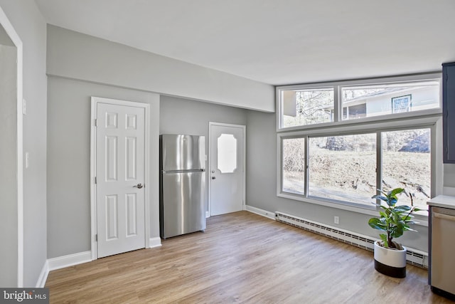 interior space with light wood-style flooring and baseboards