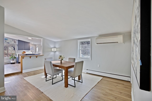 dining area with lofted ceiling, baseboard heating, a wall mounted air conditioner, and light wood-style floors