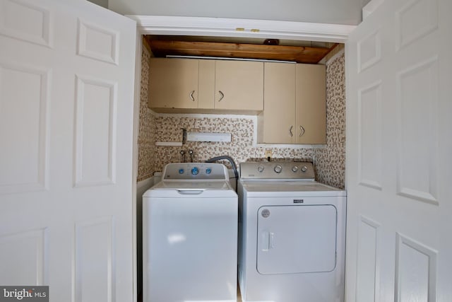 laundry area with cabinet space and independent washer and dryer