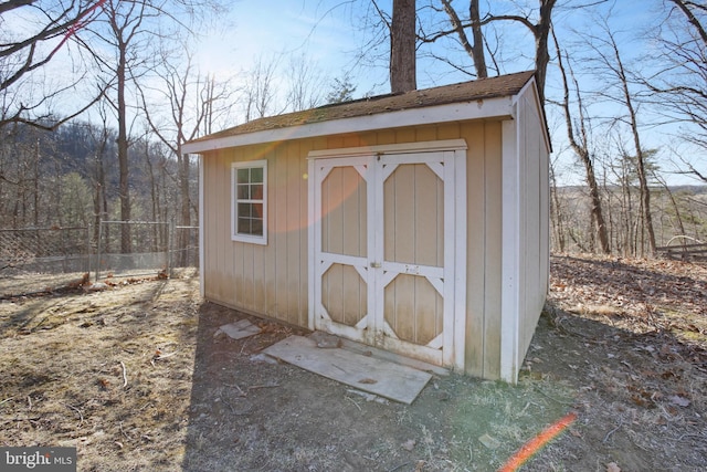 view of shed with fence