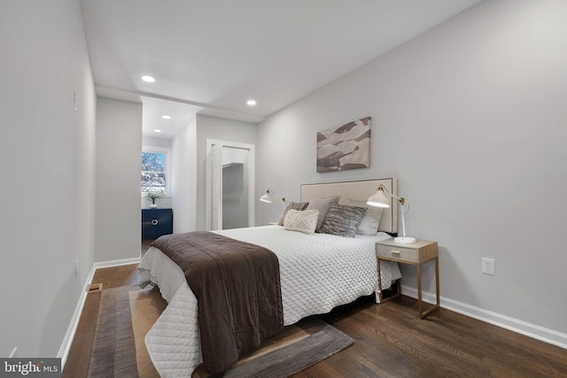 bedroom with recessed lighting, visible vents, baseboards, and wood finished floors