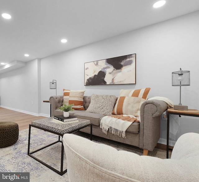 living room with recessed lighting, baseboards, and wood finished floors