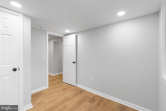 unfurnished bedroom with recessed lighting, light wood-type flooring, and baseboards