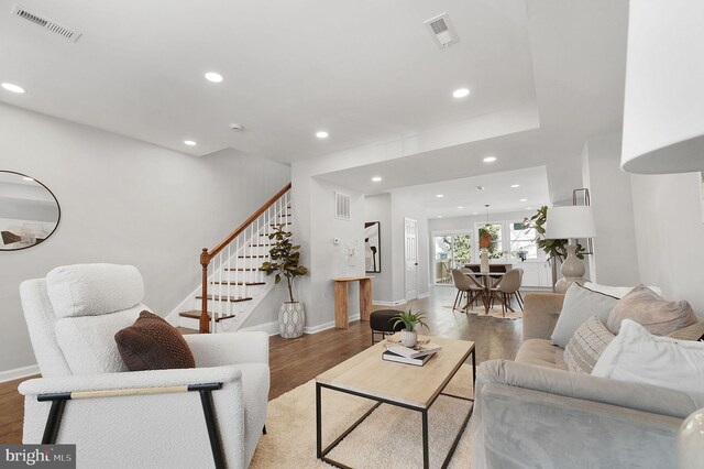 living area featuring wood finished floors and visible vents