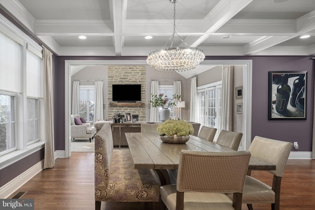 dining space featuring dark wood-type flooring, plenty of natural light, and a fireplace