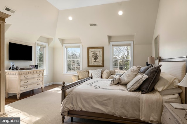 bedroom with visible vents, baseboards, recessed lighting, a high ceiling, and dark wood-style flooring