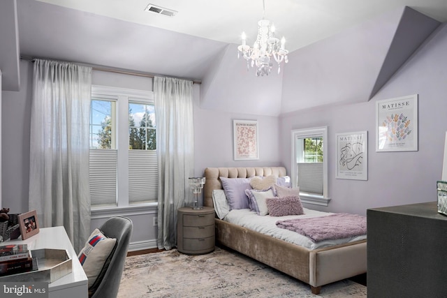 bedroom with an inviting chandelier, vaulted ceiling, wood finished floors, and visible vents