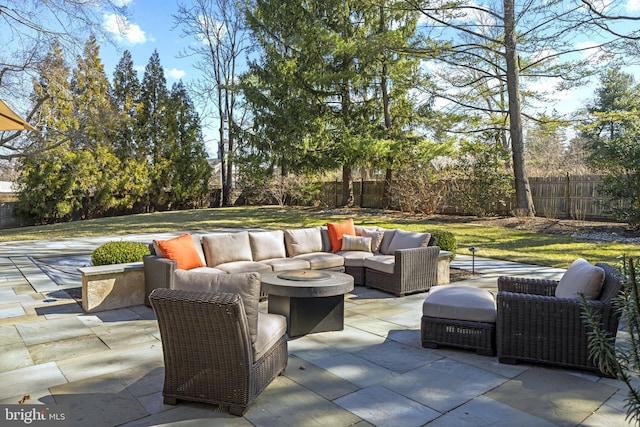 view of patio with an outdoor living space and a fenced backyard