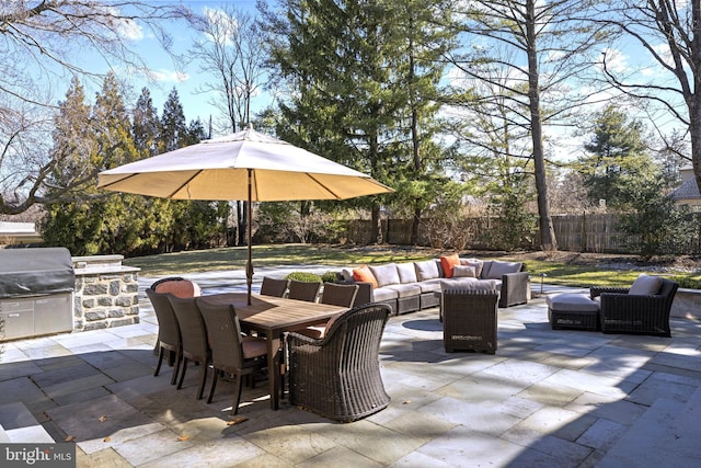 view of patio featuring an outdoor living space, outdoor dining area, a fenced backyard, and exterior kitchen