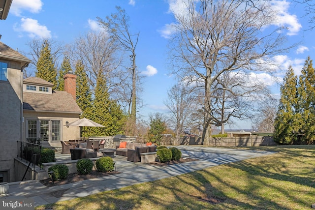 view of yard featuring an outdoor hangout area, a patio, and fence