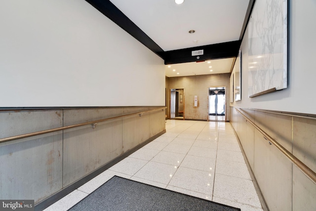 hall with recessed lighting, visible vents, and wainscoting