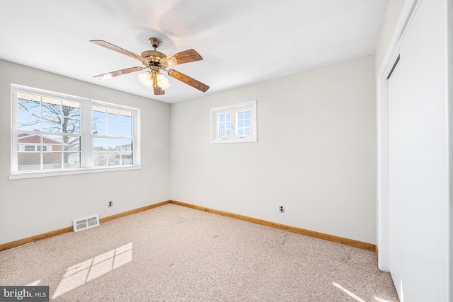 unfurnished bedroom featuring carpet, baseboards, visible vents, and a closet