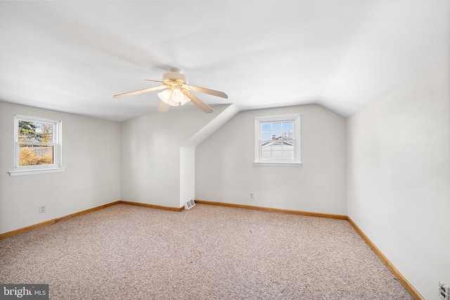 bonus room with carpet floors, lofted ceiling, plenty of natural light, and baseboards