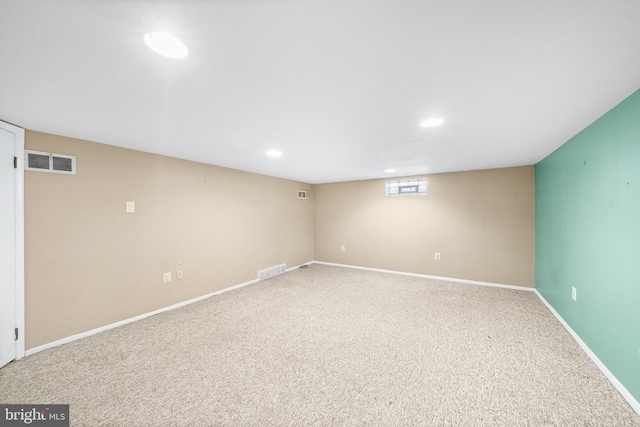 below grade area featuring carpet, visible vents, baseboards, and recessed lighting