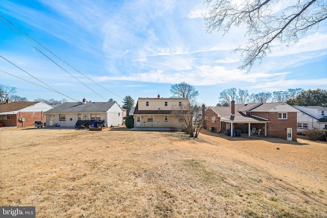 back of property with a residential view and a lawn