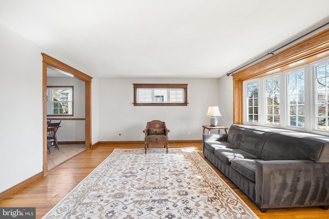 living room with light wood finished floors and baseboards