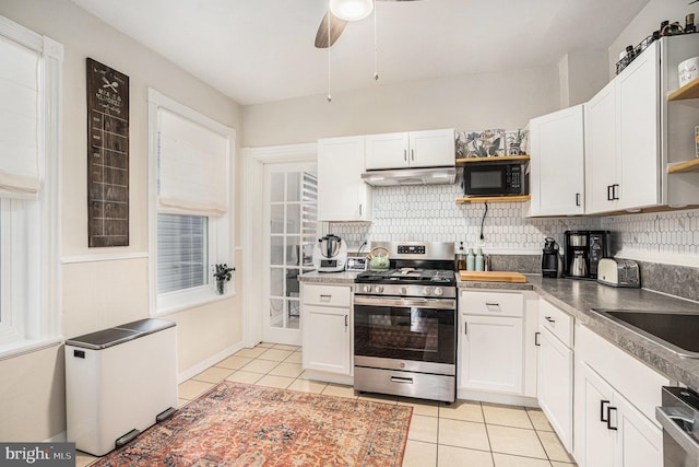 kitchen with white cabinets, under cabinet range hood, black microwave, open shelves, and gas stove