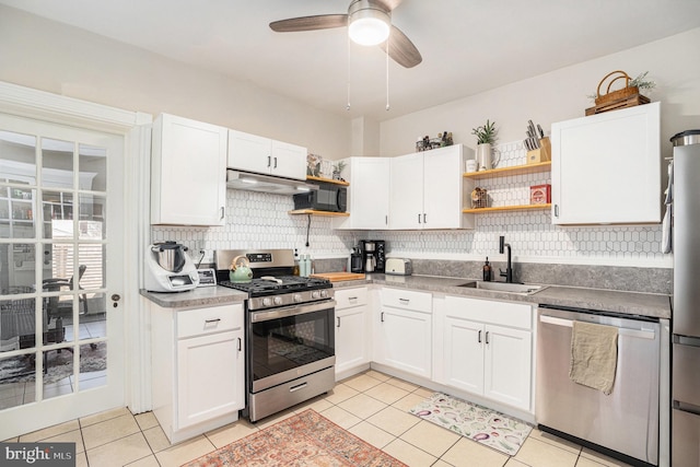 kitchen featuring open shelves, under cabinet range hood, stainless steel appliances, and a sink