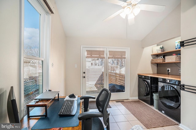 home office with lofted ceiling, light tile patterned flooring, plenty of natural light, and separate washer and dryer