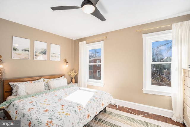 bedroom featuring ceiling fan and baseboards