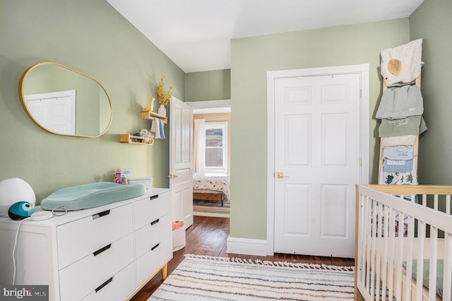 bedroom featuring dark wood finished floors and baseboards