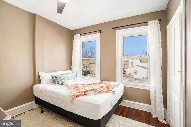 bedroom featuring baseboards and wood finished floors