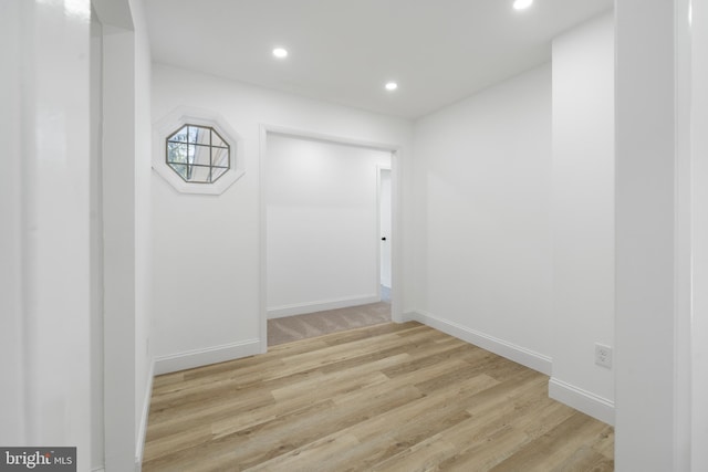 unfurnished room featuring light wood-type flooring, baseboards, and recessed lighting