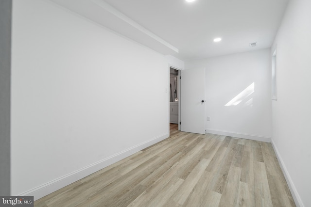 unfurnished room featuring light wood finished floors, baseboards, and recessed lighting