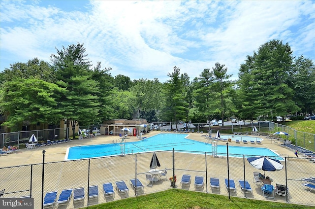 pool with fence and a patio