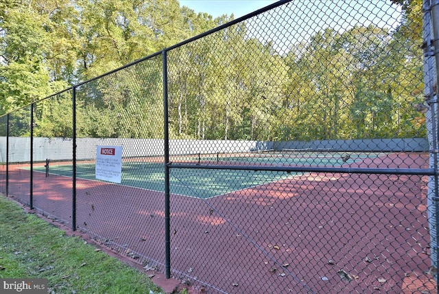 view of tennis court with fence