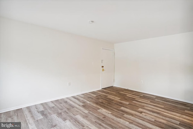 unfurnished room with light wood-style floors and baseboards